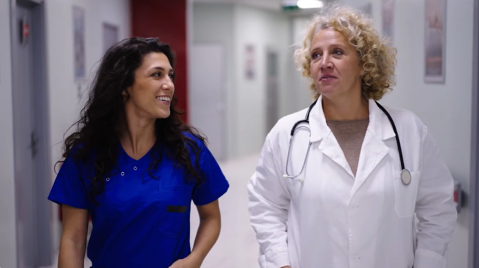 Doctor and nurse walking and talking in hallway